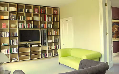 Interior wall touch-up painting with a small roller, showing close-up application of paint to blend and repair a home interior surface.