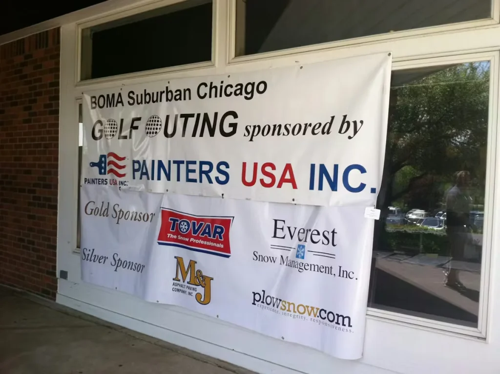 Banner for BOMA Suburban Chicago Golf Outing sponsored by Painters USA Inc., displayed outside a building with logos of gold and silver sponsors.