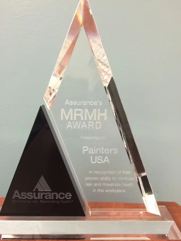 Assurance MRMH safety award presented to Painters USA for excellence in workplace health and risk management.