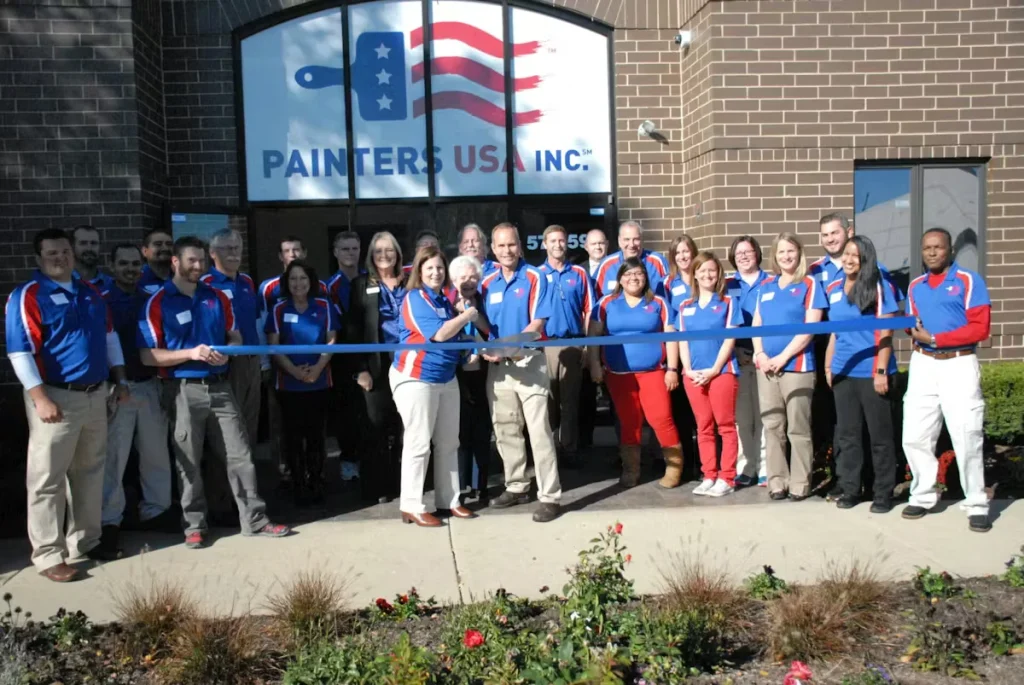Painters USA Inc. team members gathered outside company headquarters for a ribbon-cutting ceremony.