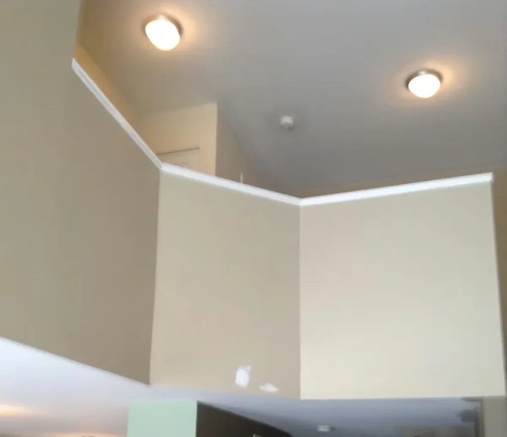 Freshly painted commercial office interior with neutral walls, white trim, and recessed ceiling lighting.