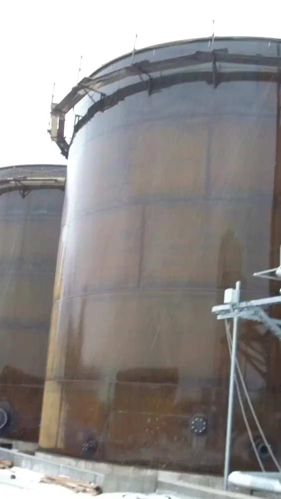Large industrial storage tanks showing surface rust and corrosion prior to protective coating or rust prevention treatment.