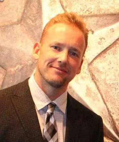 Headshot of Derek Chambers wearing a suit and tie.