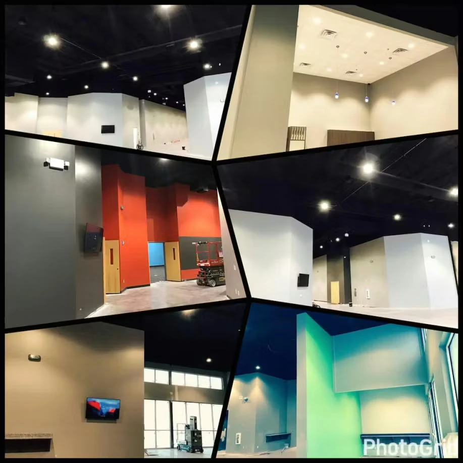 Collage of several wide-angle interior photos showing a large commercial space with high black ceilings and recessed lights, white and gray walls, a section with bright orange walls and doors, a scissor lift in one area, and a blue-green accent wall in another; “PhotoGrid” watermark appears in the lower right.