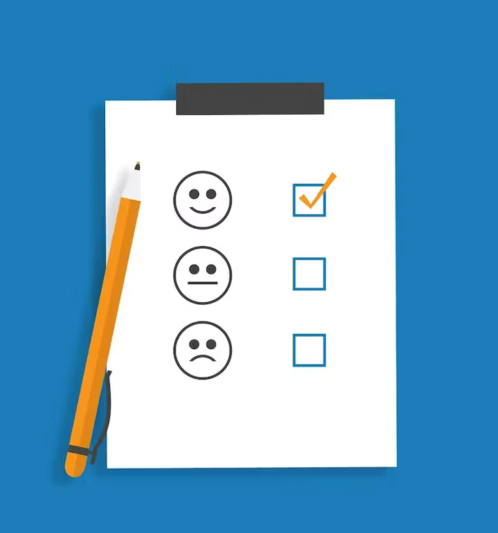 Illustration of a clipboard-style survey on a blue background with three face icons (happy, neutral, sad) and checkboxes, with a check mark next to the happy face; a yellow pencil sits along the left side.