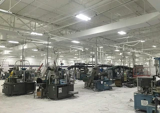 Manufacturing industry floor with multiple industrial machines and equipment.