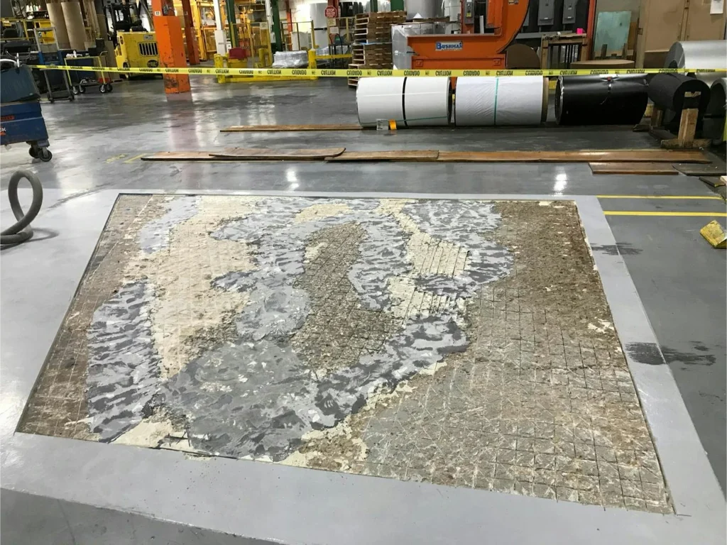 Large rectangular floor section milled out, revealing weak layers and grid scoring before rebuilding.