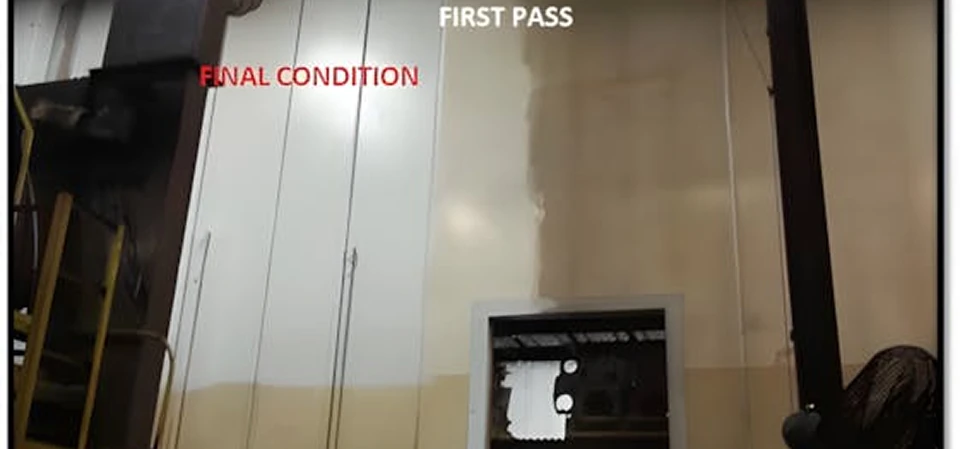 Factory wall showing cleaning progress: bright white panels labeled "FINAL CONDITION" on the left, a lighter vertical strip labeled "FIRST PASS" in the center, and the original yellowed, grime-stained wall to the right.
