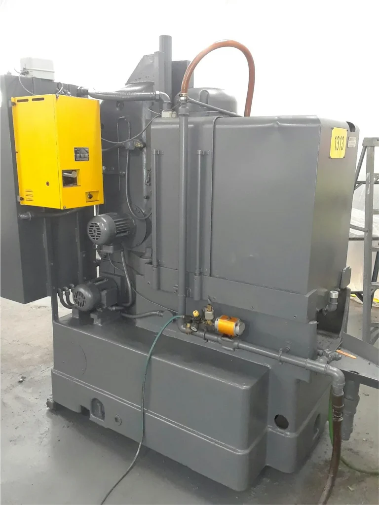 Refurbished industrial machine painted dark gray with a yellow control box, wiring neatly routed and surfaces clean.