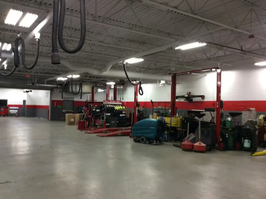Image of a car dealership repair bay with polished concrete floor.