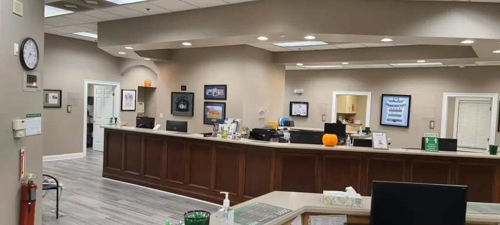 Medical clinic reception area with newly painted walls, modern lighting, and updated front desk.
