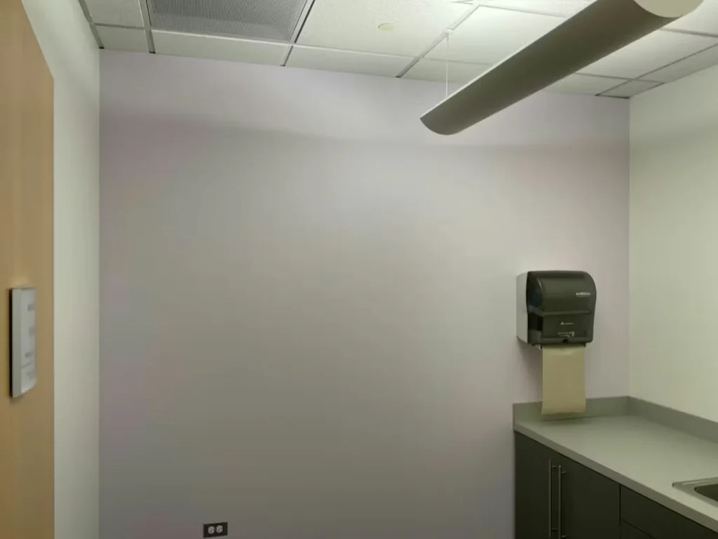 Small office meeting room with newly painted accent wall and modern furniture