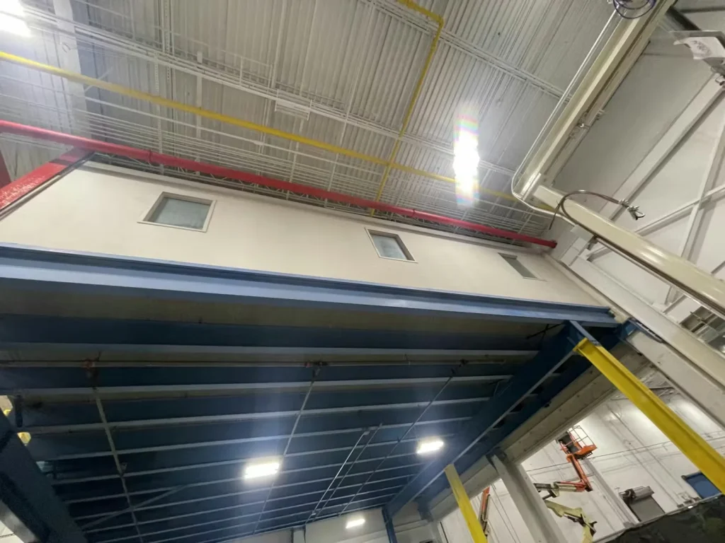 Industrial mezzanine and overhead piping after facility revitalization