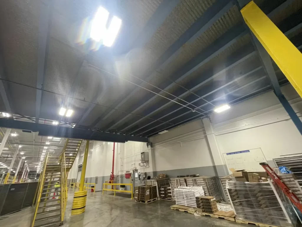 Warehouse interior with repainted steel mezzanine and safety railings