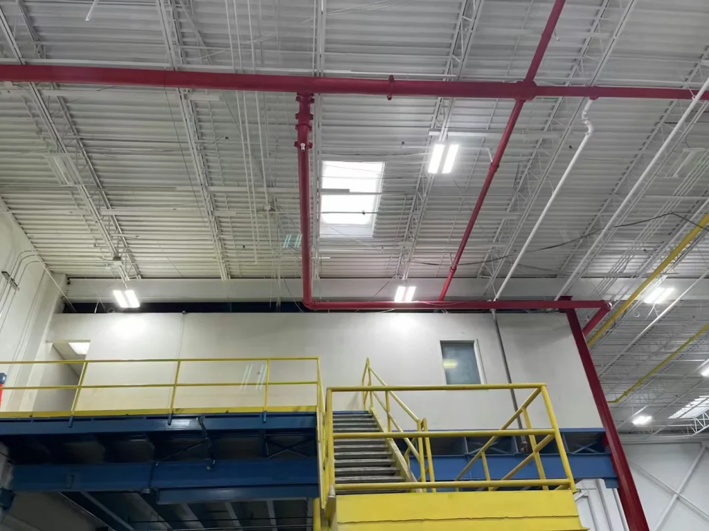 Interior plant renovation with scissor lift and ceiling work in progress