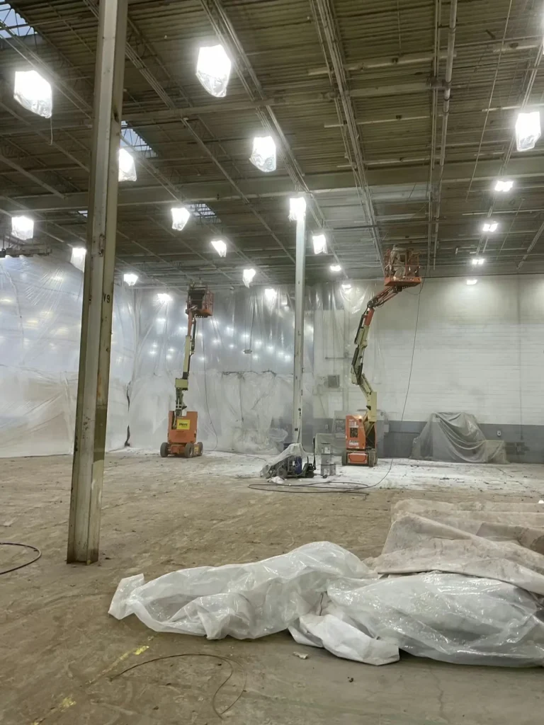 Wide view of renovated manufacturing floor with lighting and ceiling improvements