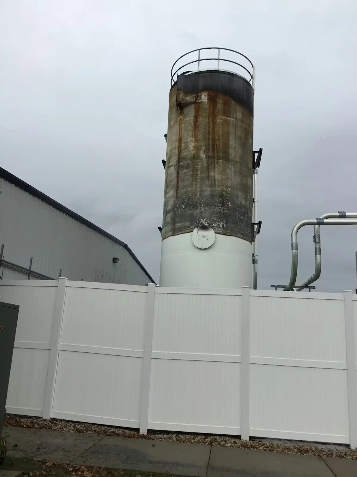 Weathered industrial silo showing rust stains and surface deterioration prior to cleaning and repainting
