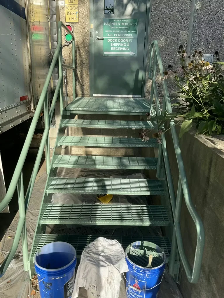 Refurbished epoxy-coated steel stairs and railings at food and beverage distribution dock