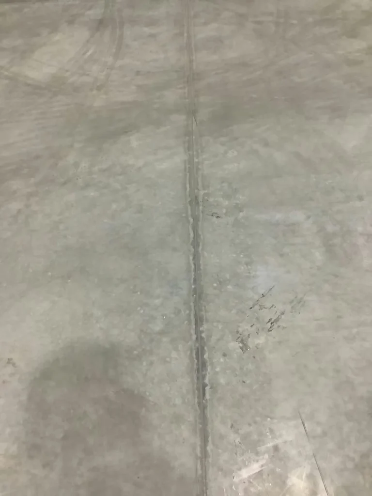 Close-up of warehouse concrete expansion joint prepared for sealing and repair