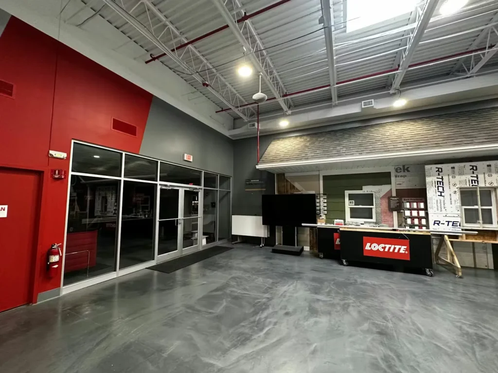 Industrial showroom with glass doors, display counter, and polished concrete floor
